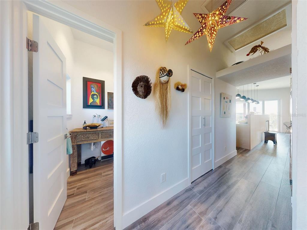 901 Sheepshead Avenue New Smyrna Beach, FL 32169 - Photo 24 of 64 a view of a hallway with wooden floor and a living room