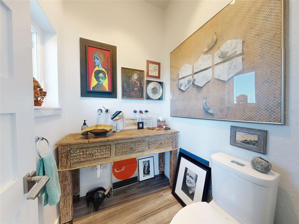 901 Sheepshead Avenue New Smyrna Beach, FL 32169 - Photo 25 of 64 a bathroom with a toilet a sink and a mirror