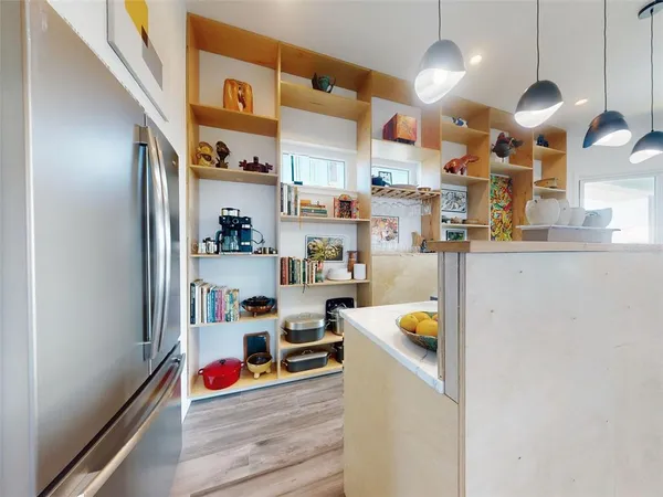 a large kitchen with stainless steel appliances lots of counter space and a sink