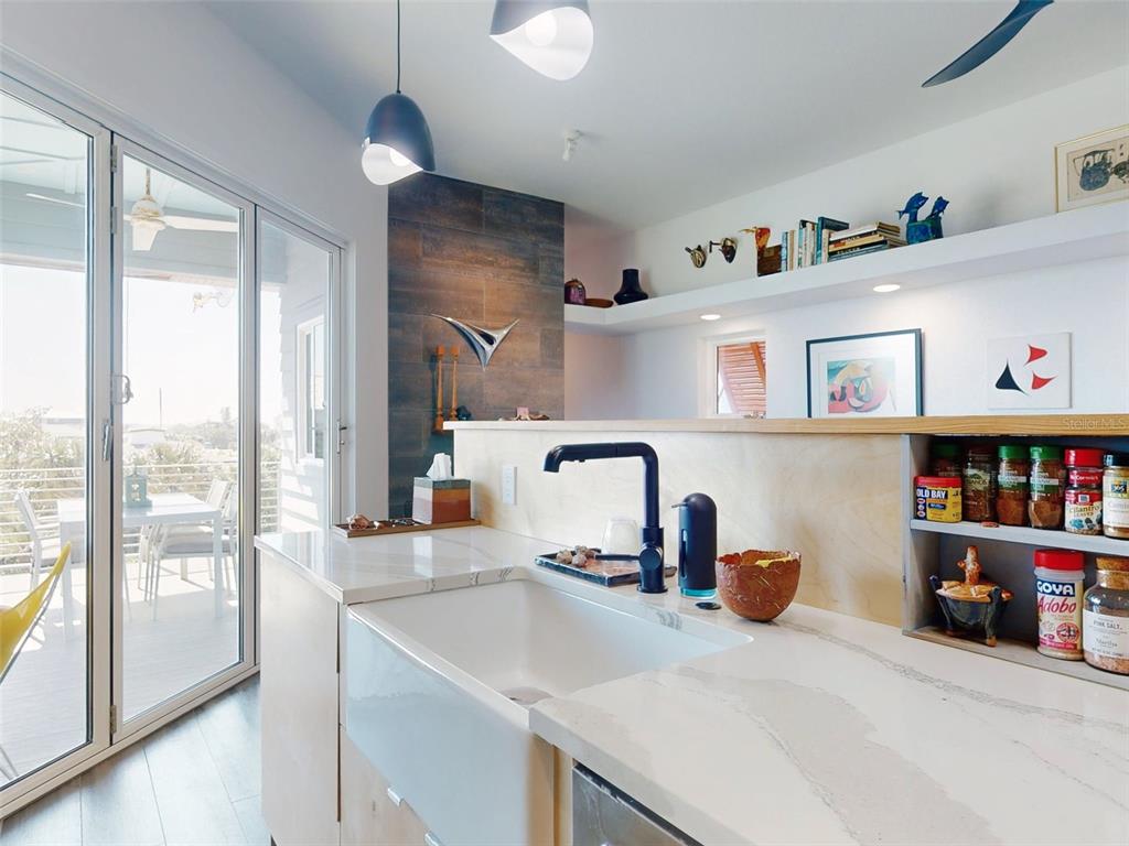 901 Sheepshead Avenue New Smyrna Beach, FL 32169 - Photo 31 of 64 a kitchen with a two sinks a large window and a counter space