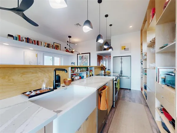 a dining room with wooden floor and large window