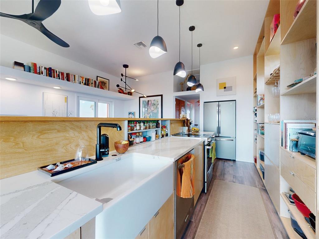 901 Sheepshead Avenue New Smyrna Beach, FL 32169 - Photo 33 of 64 a large kitchen with stainless steel appliances lots of counter space and a sink