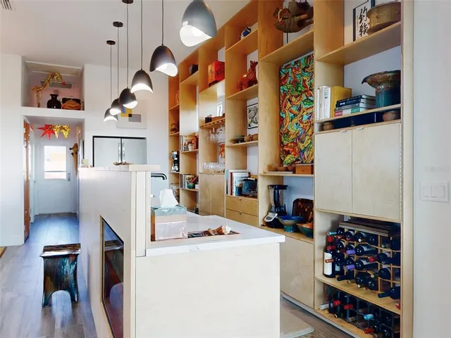 a living room with lots of furniture and kitchen view