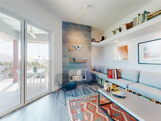 a living room with furniture and a floor to ceiling window