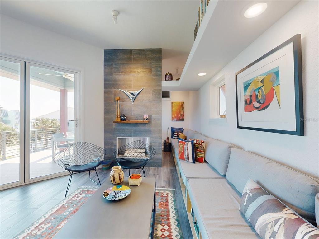 901 Sheepshead Avenue New Smyrna Beach, FL 32169 - Photo 42 of 64 a living room with furniture and a floor to ceiling window