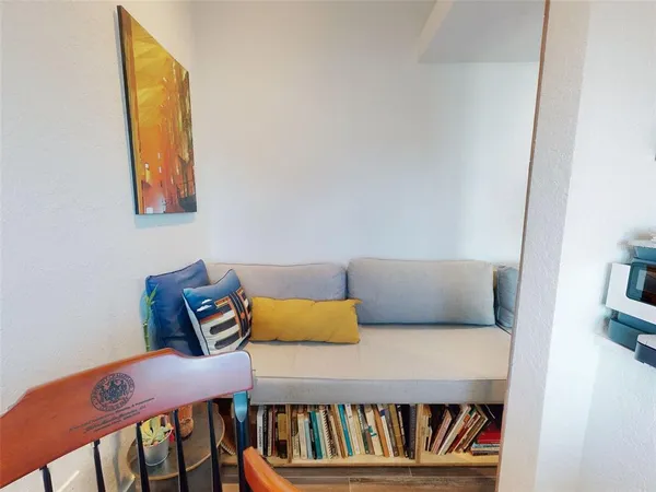 a front view of a house with large trees