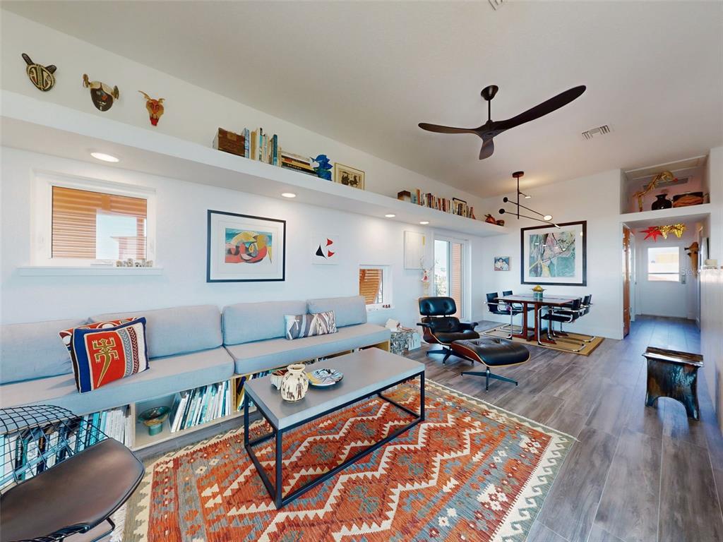901 Sheepshead Avenue New Smyrna Beach, FL 32169 - Photo 47 of 64 a living room with furniture kitchen view and a wooden floor