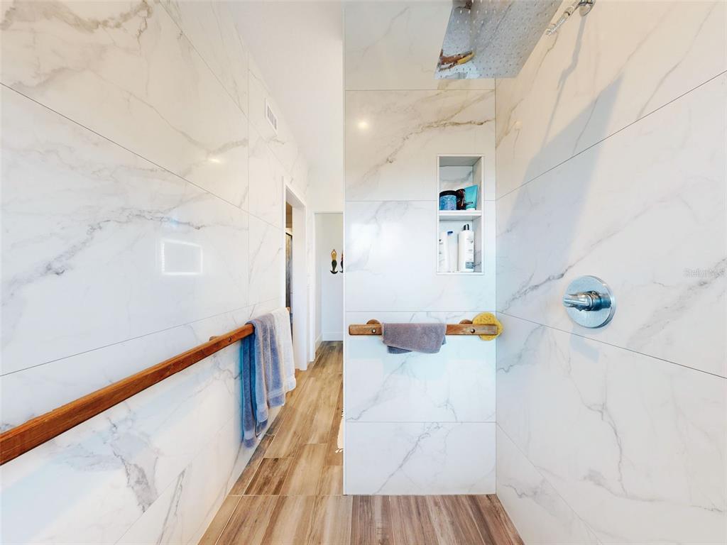 901 Sheepshead Avenue New Smyrna Beach, FL 32169 - Photo 48 of 64 a hallway with a dining table and chairs