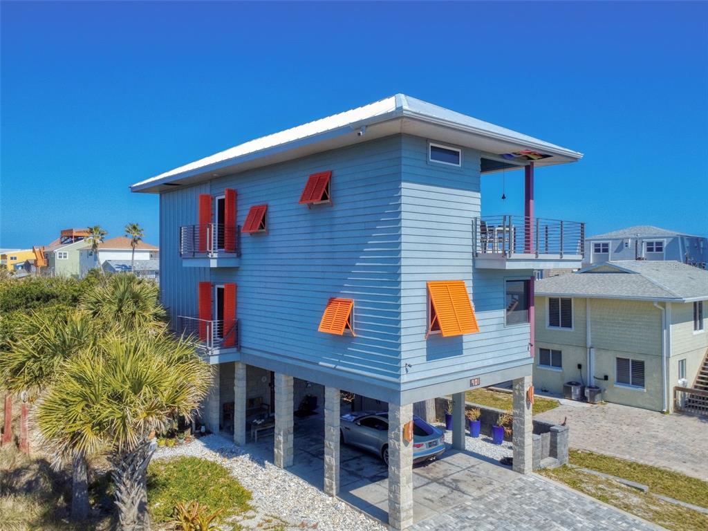 901 Sheepshead Avenue New Smyrna Beach, FL 32169 - Photo 54 of 64 a front view of a house with large trees