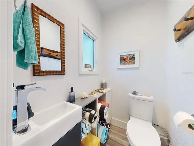 a bathroom with a sink toilet and mirror