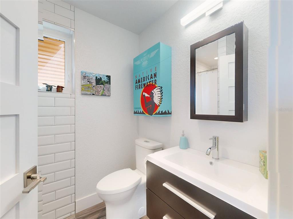 901 Sheepshead Avenue New Smyrna Beach, FL 32169 - Photo 8 of 64 a bathroom with a sink toilet and mirror