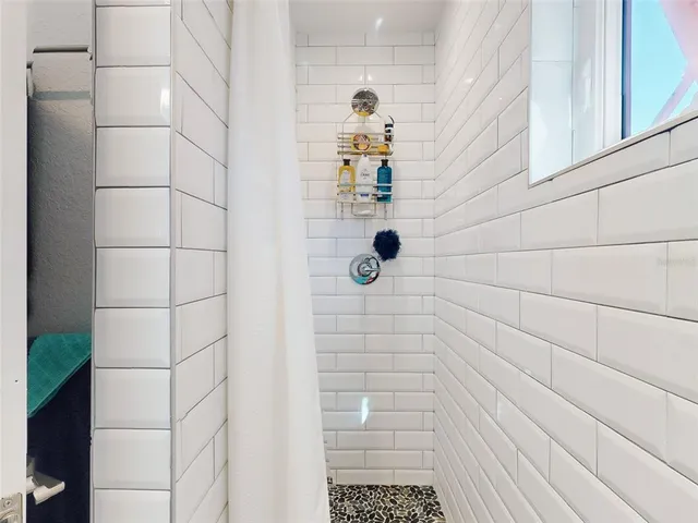 a view of a hallway with wooden floor and living room