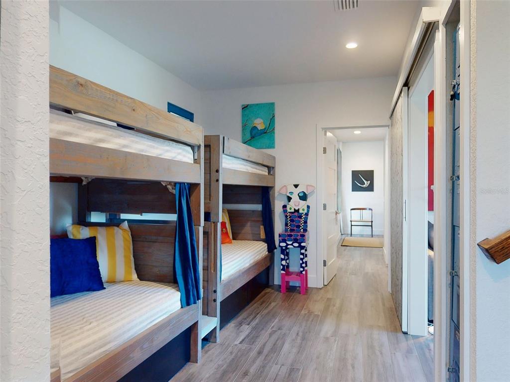 901 Sheepshead Avenue New Smyrna Beach, FL 32169 - Photo 10 of 64 a bedroom with a bed and a mirror