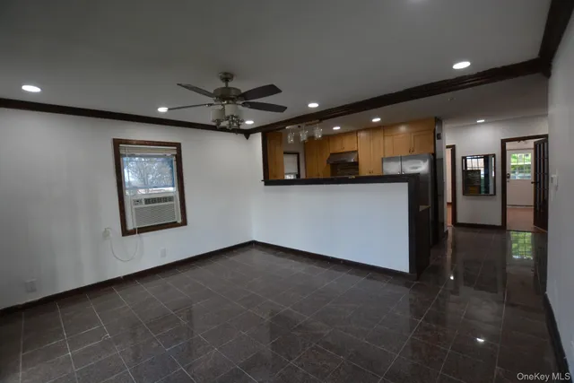 a view of an empty room with a ceiling fan