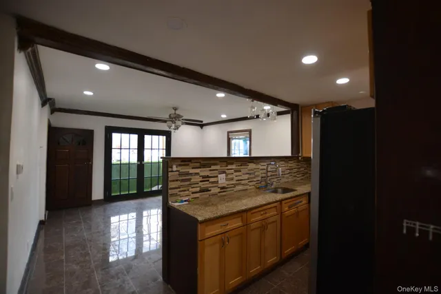 a kitchen with stainless steel appliances granite countertop a stove sink and cabinets
