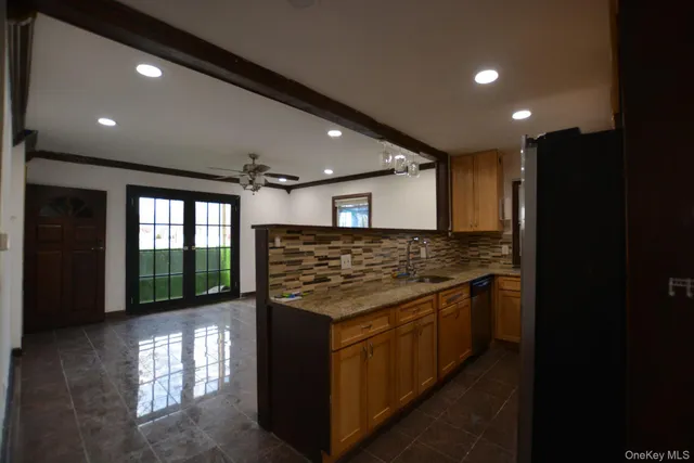 a kitchen with stainless steel appliances granite countertop a stove and a refrigerator