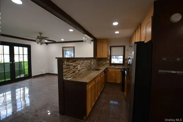 a kitchen with granite countertop a refrigerator and a stove