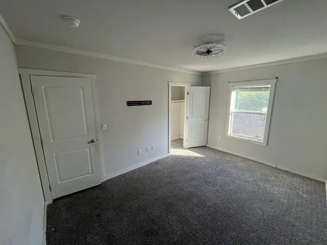 a view of walk in closet with empty racks