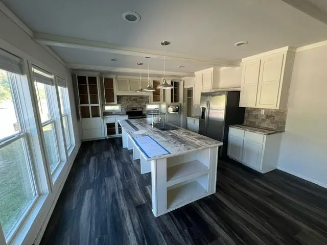 a kitchen with stainless steel appliances granite countertop a stove and a refrigerator