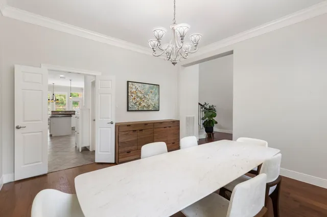a view of a dining room with furniture wooden floor and a chandelier
