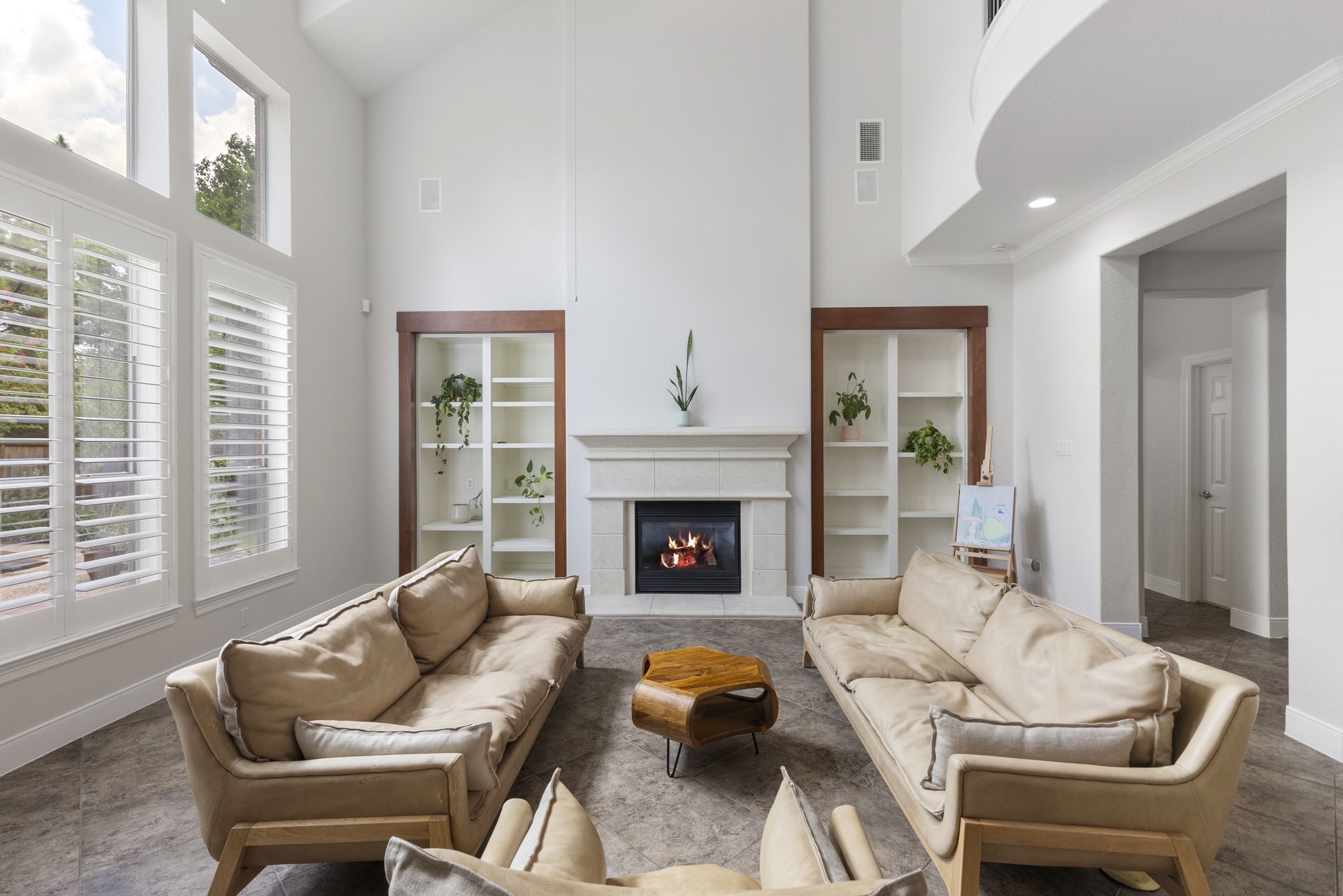 6 Skipwith Place Spring, TX 77382 - Photo 14 of 44 a living room with furniture a fireplace and a large window
