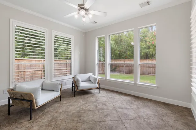 a living room with furniture and a large window with outer view