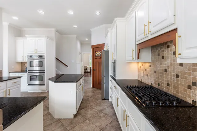 a kitchen with stainless steel appliances granite countertop a stove and a refrigerator