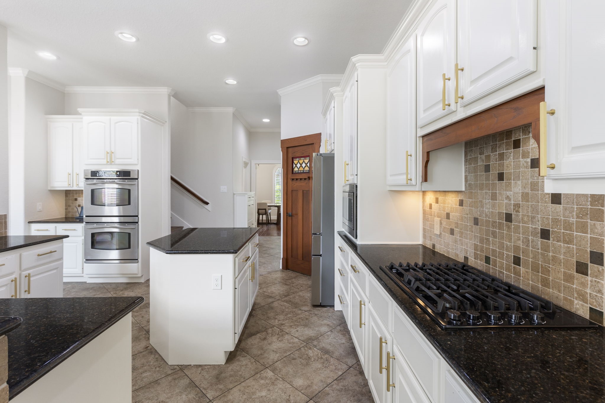 6 Skipwith Place Spring, TX 77382 - Photo 20 of 44 a kitchen with stainless steel appliances granite countertop a stove and a refrigerator