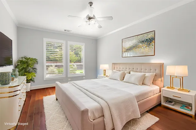 a spacious bedroom with a bed and a chandelier