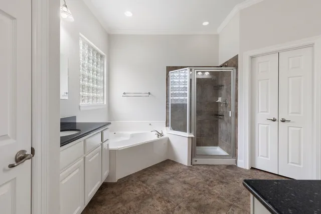 a spacious bathroom with a bathtub a toilet a sink and shower