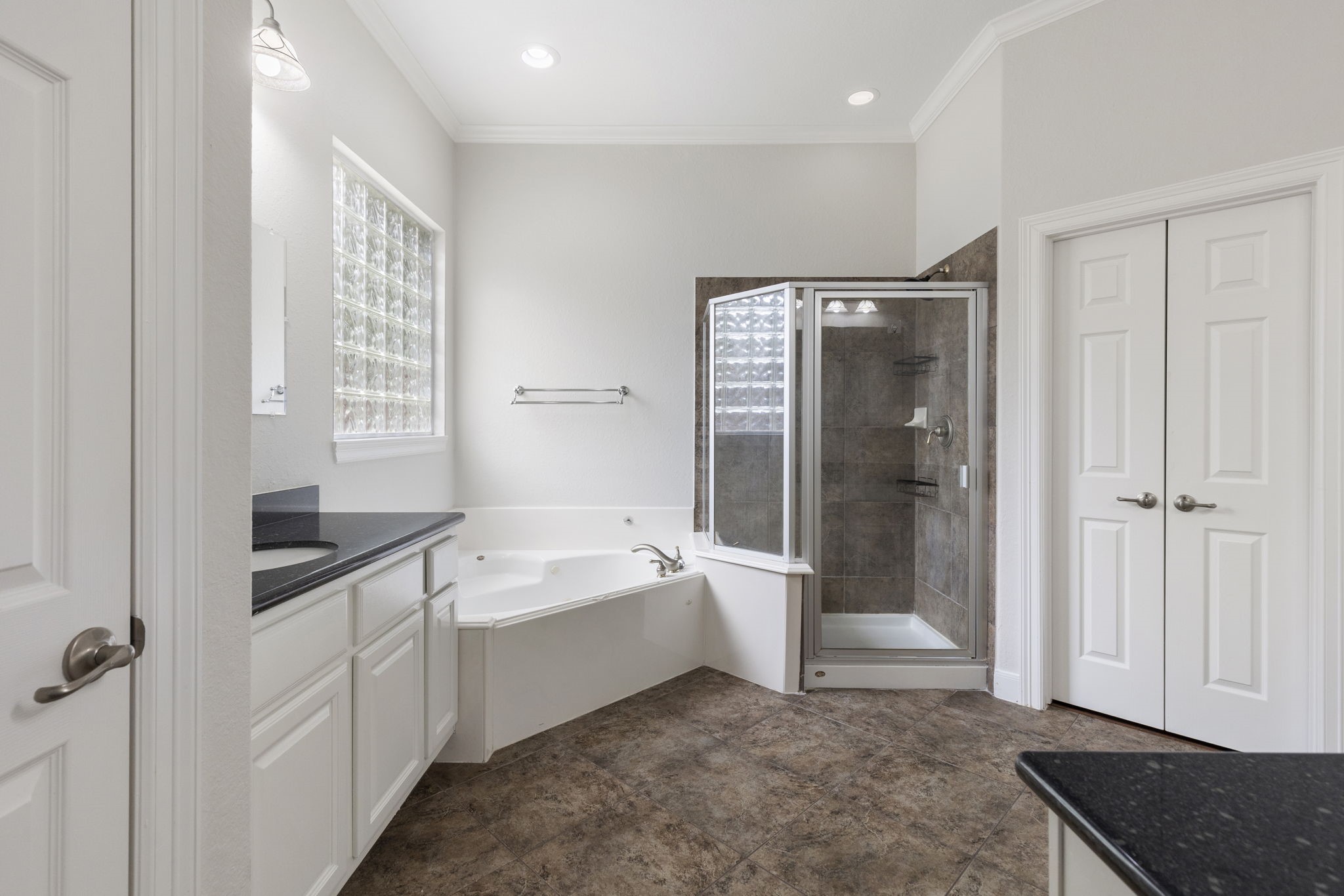 6 Skipwith Place Spring, TX 77382 - Photo 23 of 44 a spacious bathroom with a bathtub a toilet a sink and shower