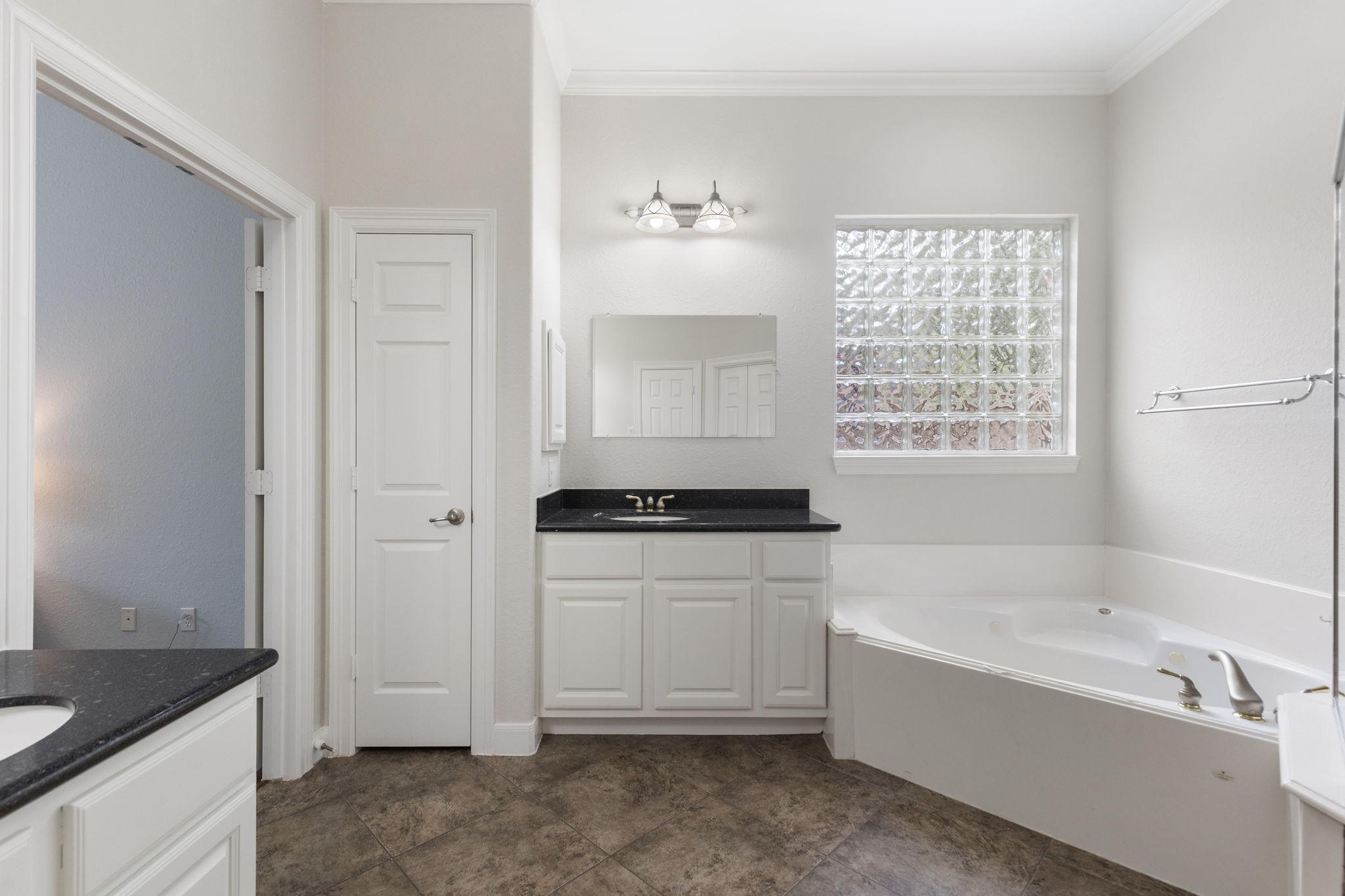 6 Skipwith Place Spring, TX 77382 - Photo 25 of 44 a bathroom with a bathtub sink and mirror