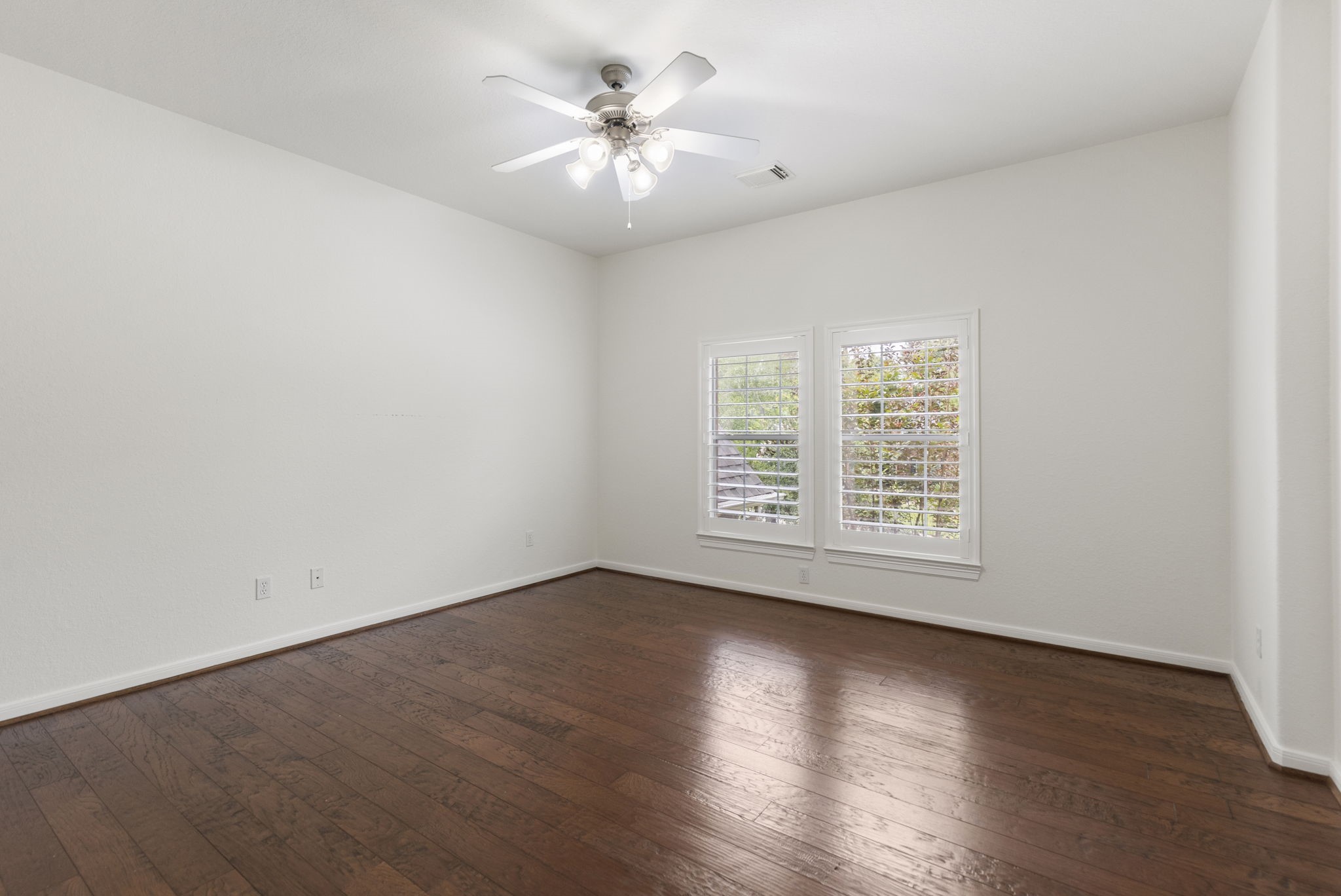 6 Skipwith Place Spring, TX 77382 - Photo 37 of 44 an empty room with wooden floor and windows