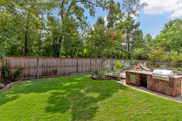 a view of a backyard with seating area and green space