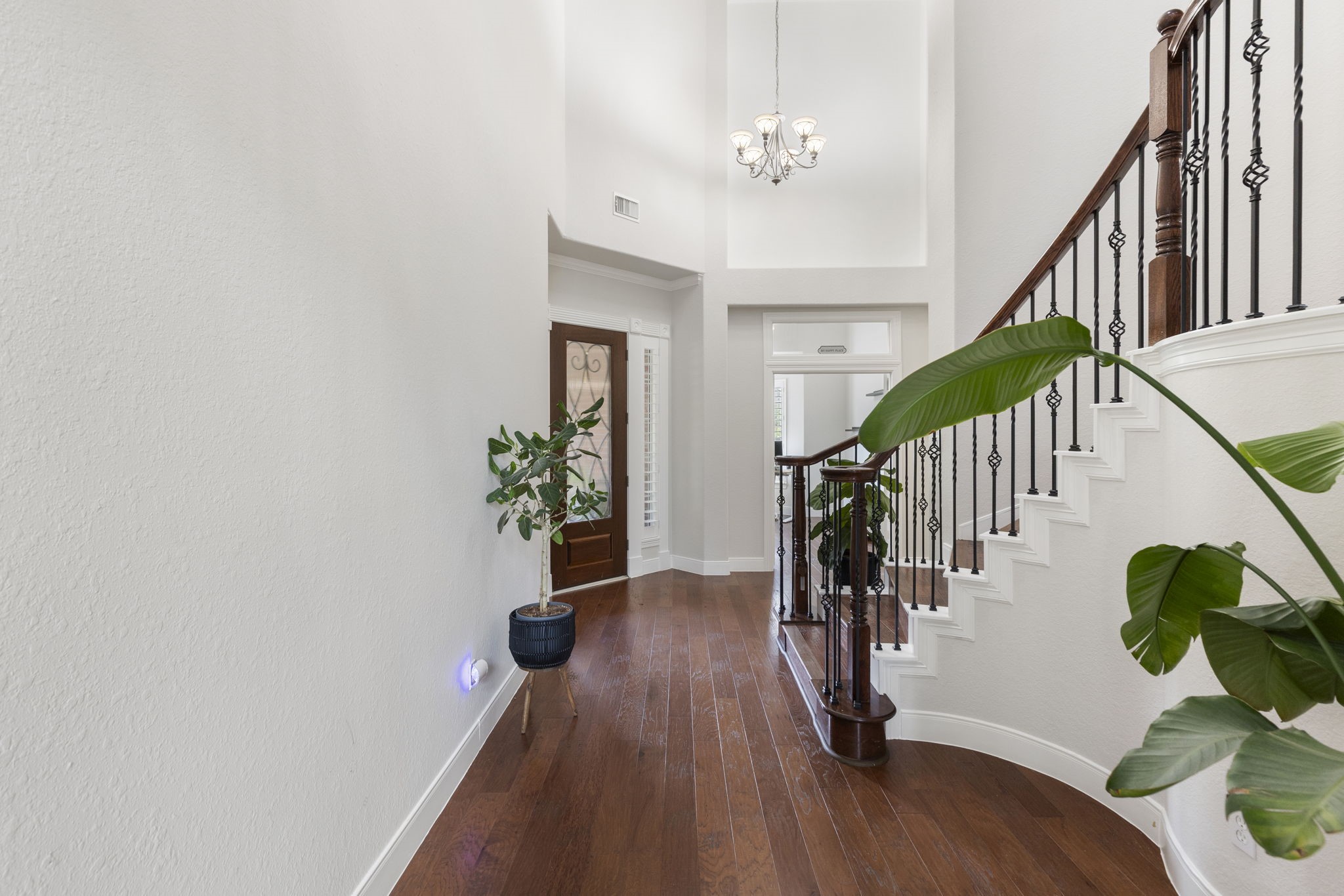 6 Skipwith Place Spring, TX 77382 - Photo 7 of 44 a hallway with wooden floor and stairs