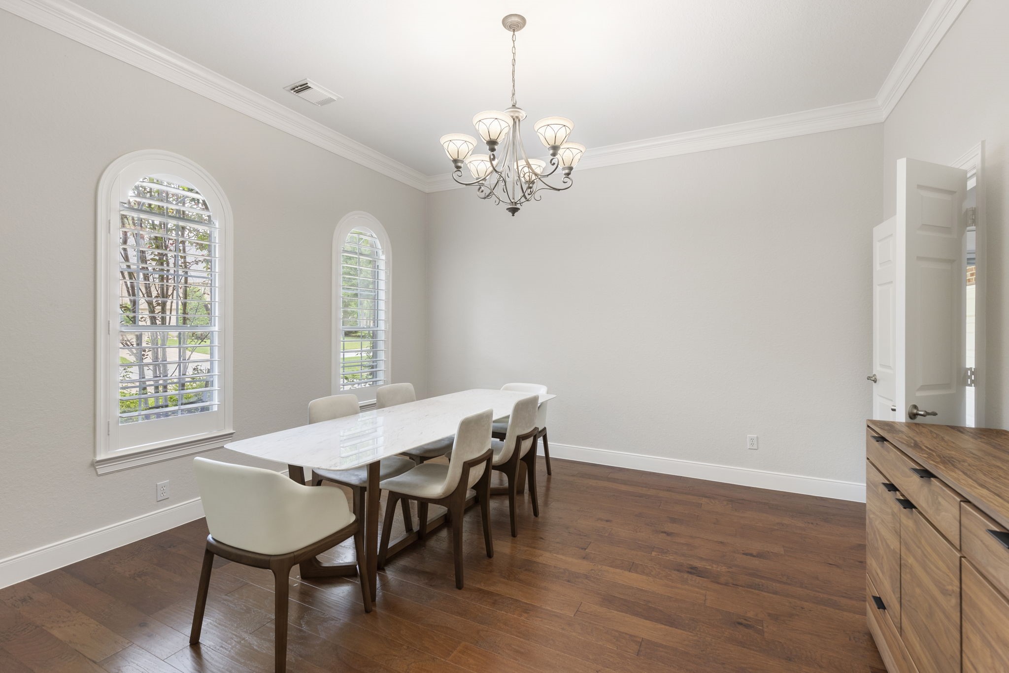 6 Skipwith Place Spring, TX 77382 - Photo 10 of 44 a view of a dining room with furniture a chandelier and wooden floor