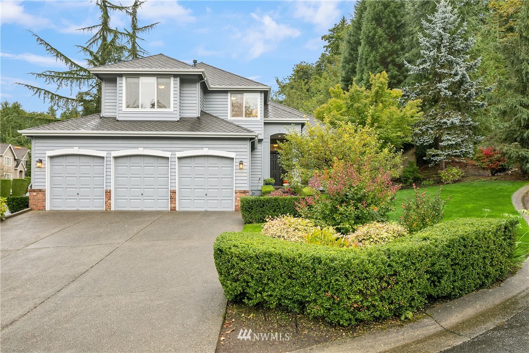 14633 Southeast 82nd Court Newcastle, WA 98059 - Photo 1 of 34 a front view of a house with a yard and garage