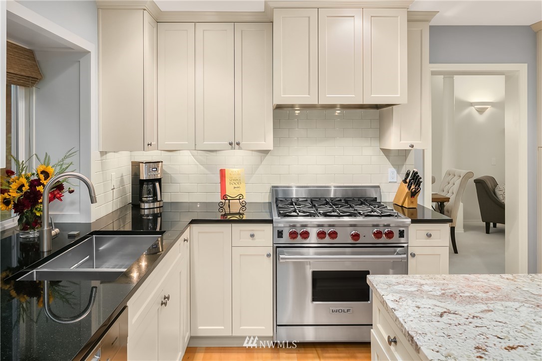 14633 Southeast 82nd Court Newcastle, WA 98059 - Photo 13 of 34 a kitchen with granite countertop a sink stainless steel appliances and cabinets