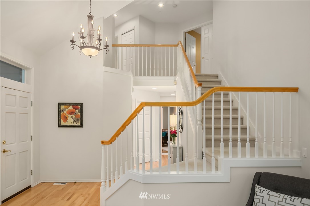14633 Southeast 82nd Court Newcastle, WA 98059 - Photo 19 of 34 a view of staircase with railing and a chandelier