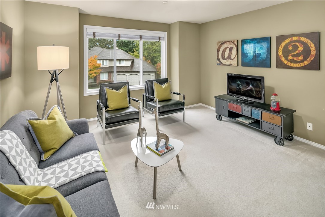 14633 Southeast 82nd Court Newcastle, WA 98059 - Photo 23 of 34 a living room with furniture and a flat screen tv