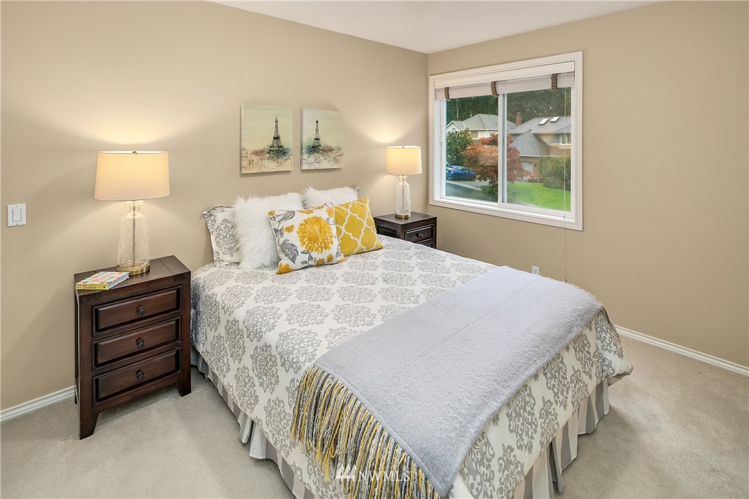14633 Southeast 82nd Court Newcastle, WA 98059 - Photo 24 of 34 a bedroom with a bed and a lamp on dresser
