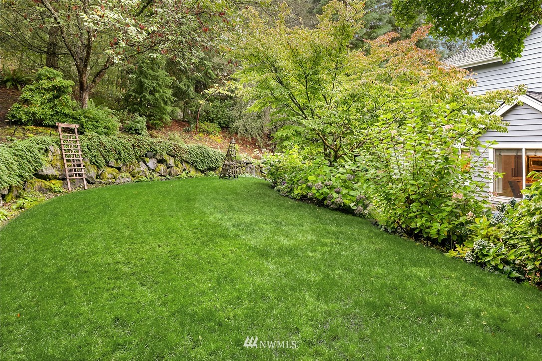 14633 Southeast 82nd Court Newcastle, WA 98059 - Photo 34 of 34 a view of a backyard with plants and large trees