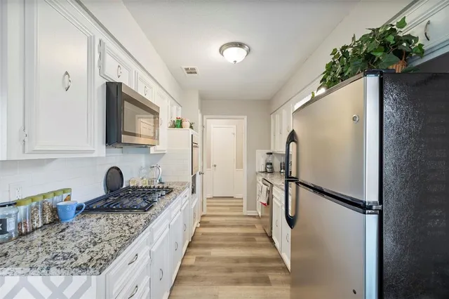 a kitchen with a refrigerator and a sink