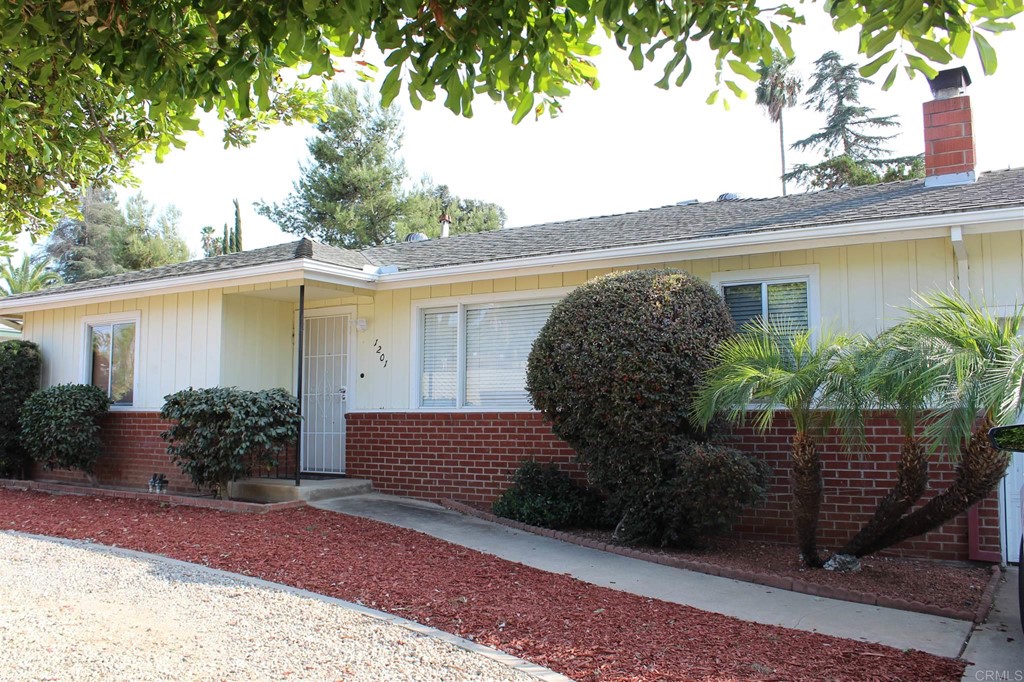 front view of a house with potted plants