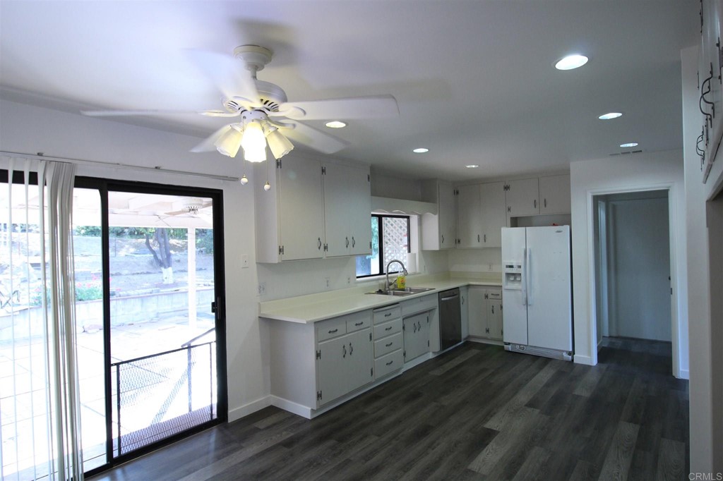 1201 Pepper Drive El Cajon, CA 92021 - Photo 4 of 15 a kitchen with kitchen island wooden floors appliances and cabinets