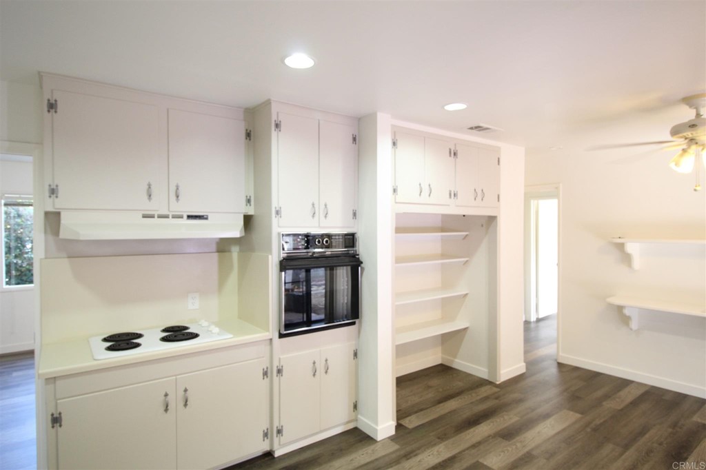 1201 Pepper Drive El Cajon, CA 92021 - Photo 5 of 15 a kitchen with cabinets and wooden floor