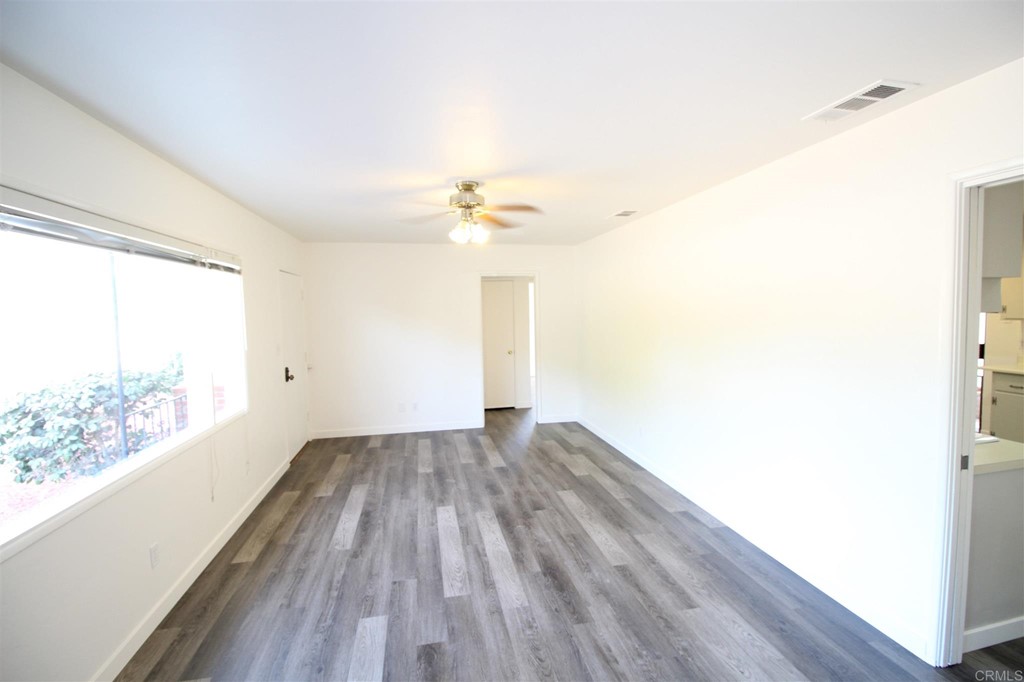 1201 Pepper Drive El Cajon, CA 92021 - Photo 7 of 15 a view of empty room with wooden floor and fan