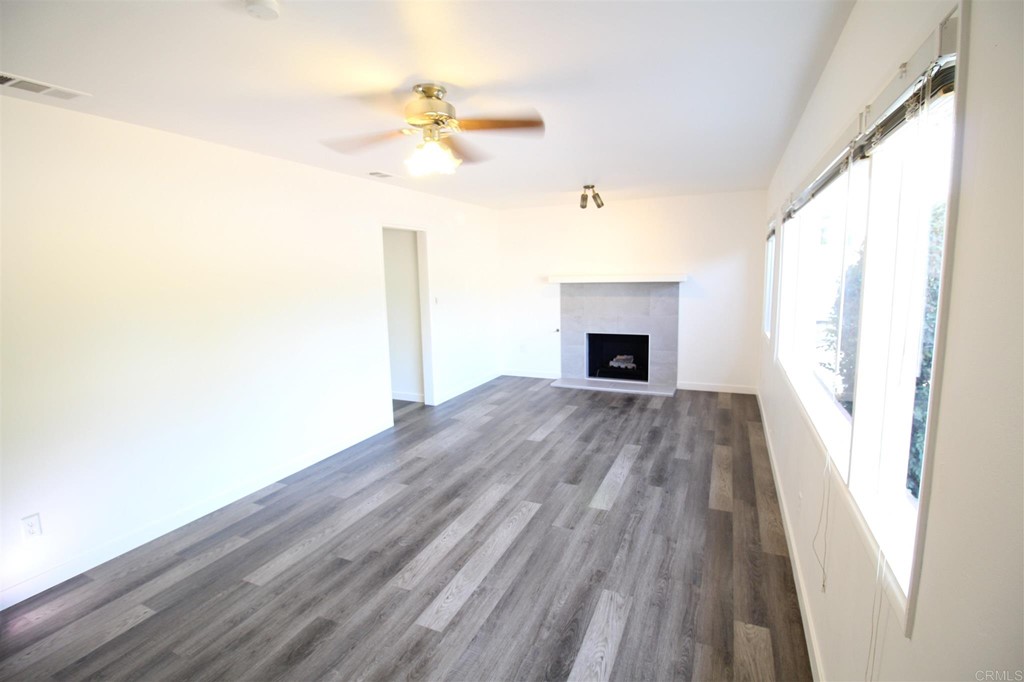 1201 Pepper Drive El Cajon, CA 92021 - Photo 8 of 15 a view of a livingroom with wooden floor and a ceiling fan