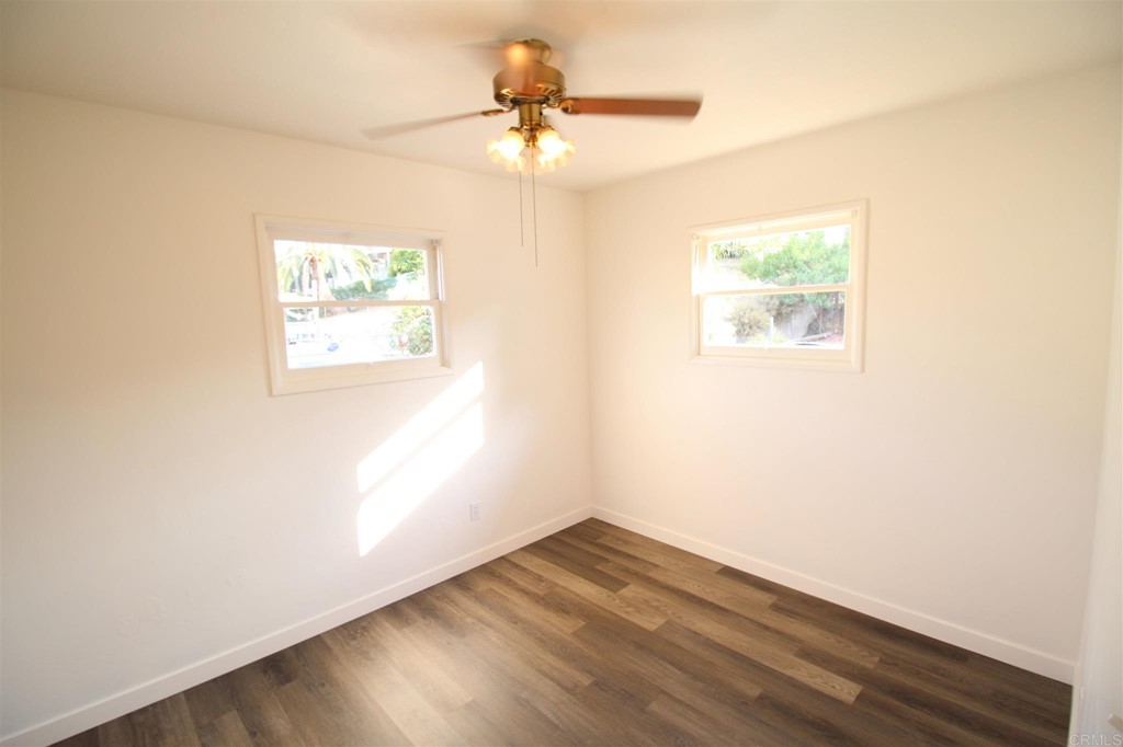 1201 Pepper Drive El Cajon, CA 92021 - Photo 10 of 15 an empty room with wooden floor and windows
