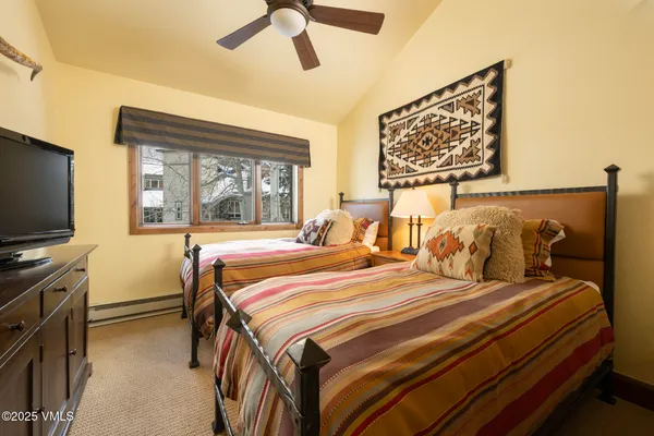 a bathroom with a granite countertop sink a mirror and shower